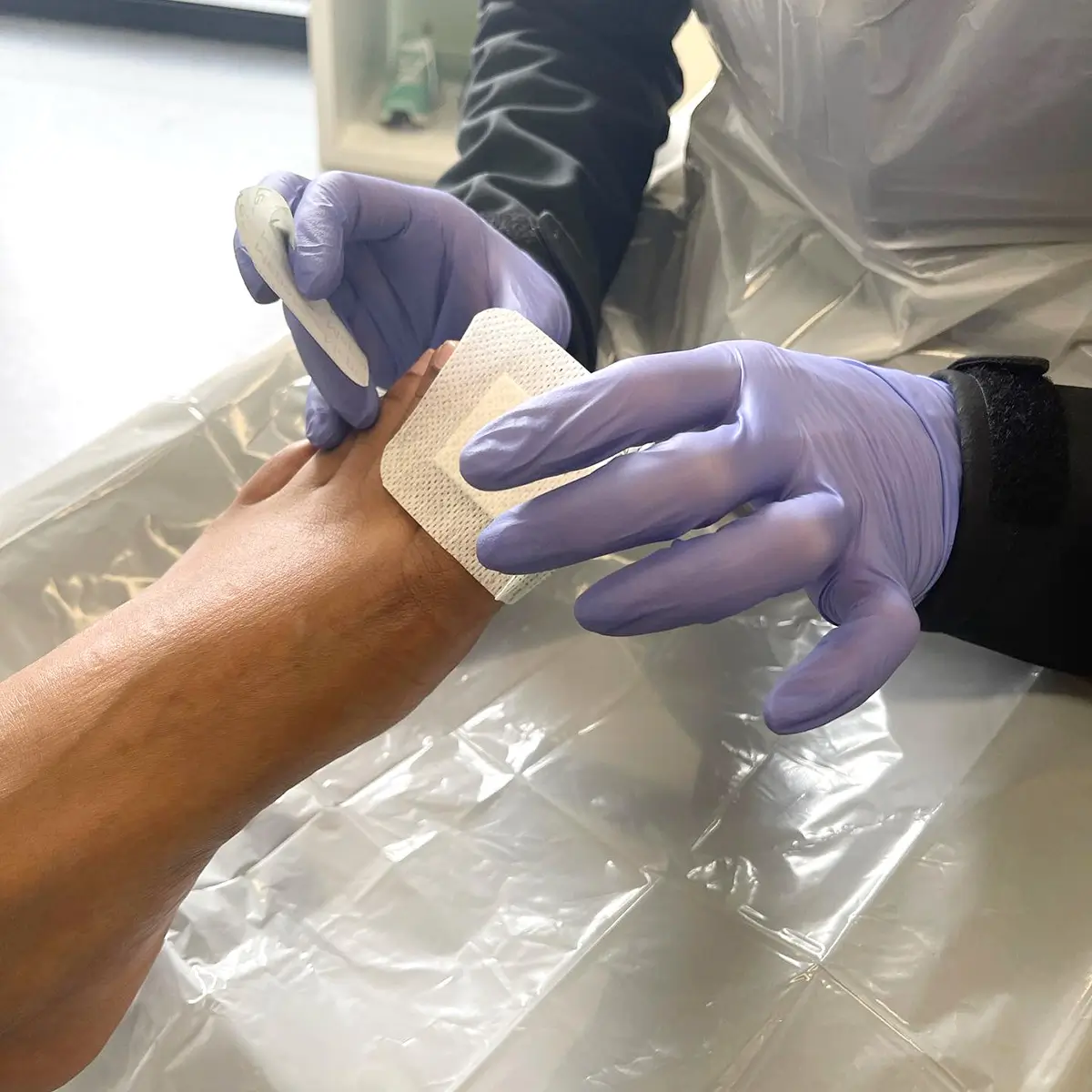 A podiatrist works on a patient's foot